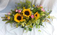 Large top table piece, sunflowers, roses, gypsophila and greenery
